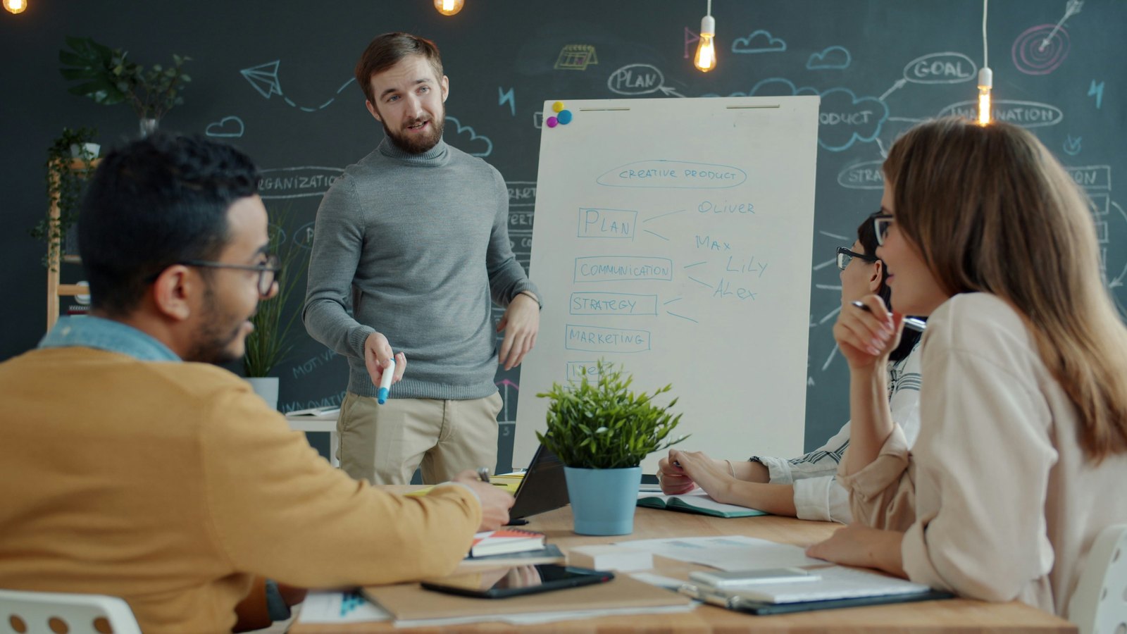 Strategy session with a presenter at a whiteboard and team taking notes