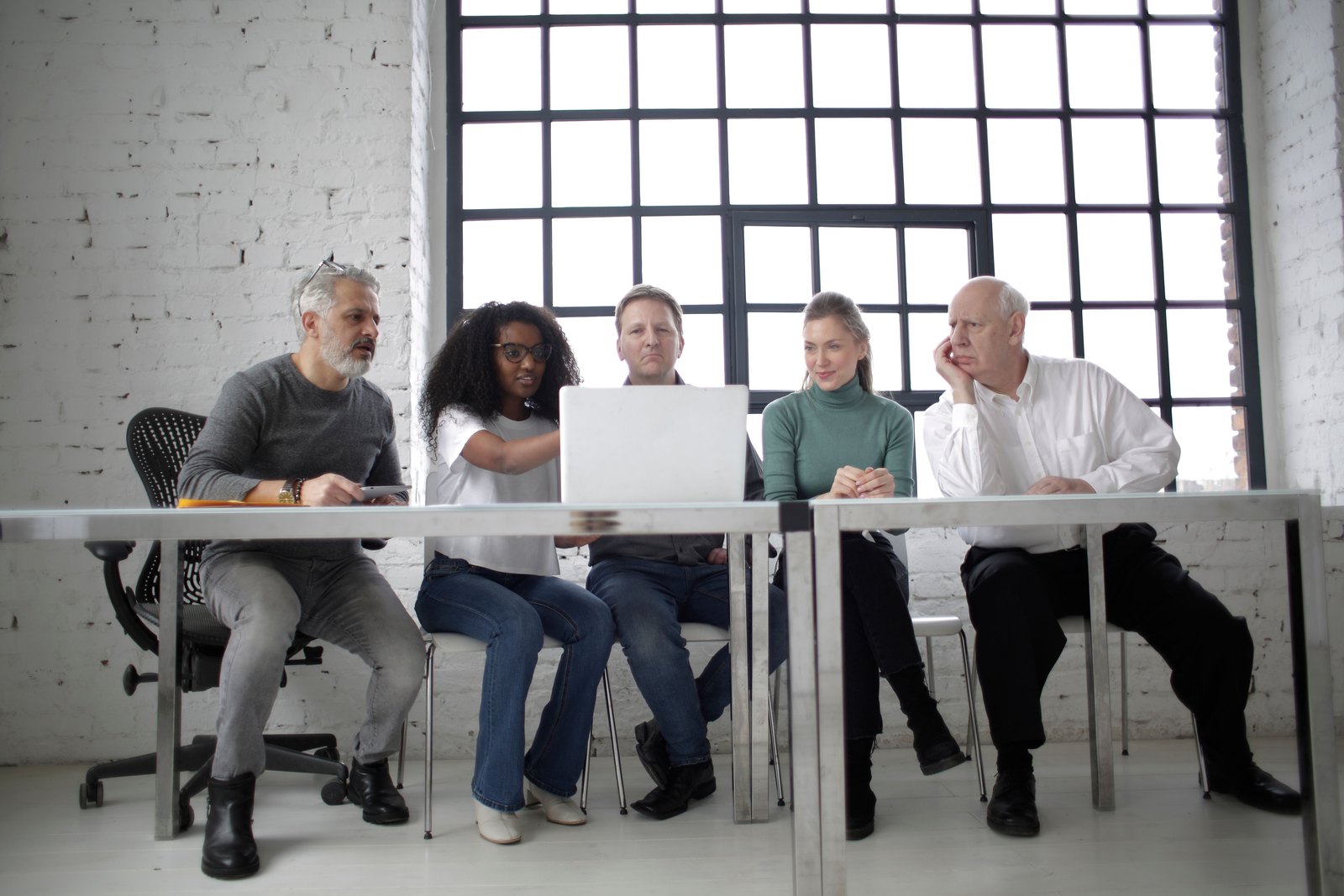 Project team seated together behind laptops during a working session