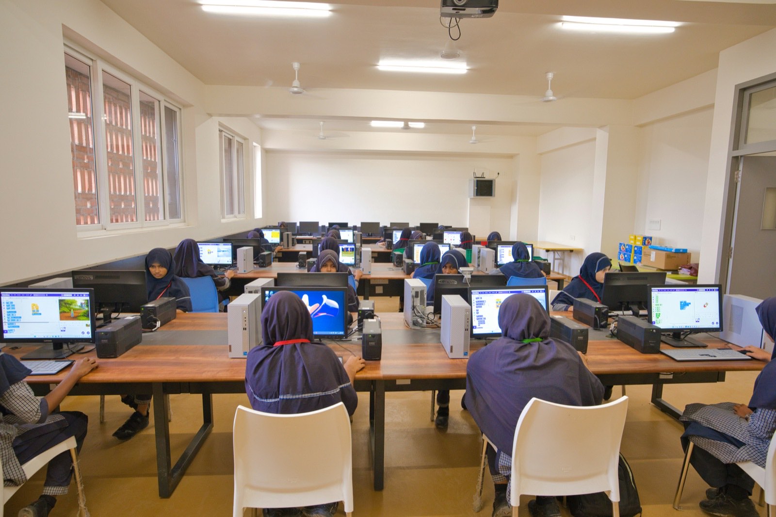 Hands-on cybersecurity training lab with learners at workstations Technical training lab with rows of learners working at computers